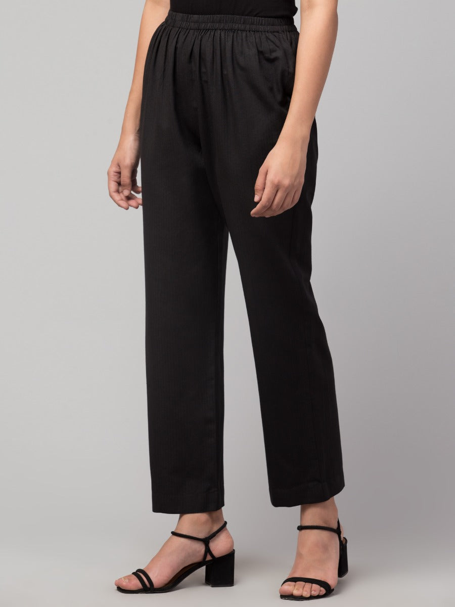 Black solid, high-rise trouser.