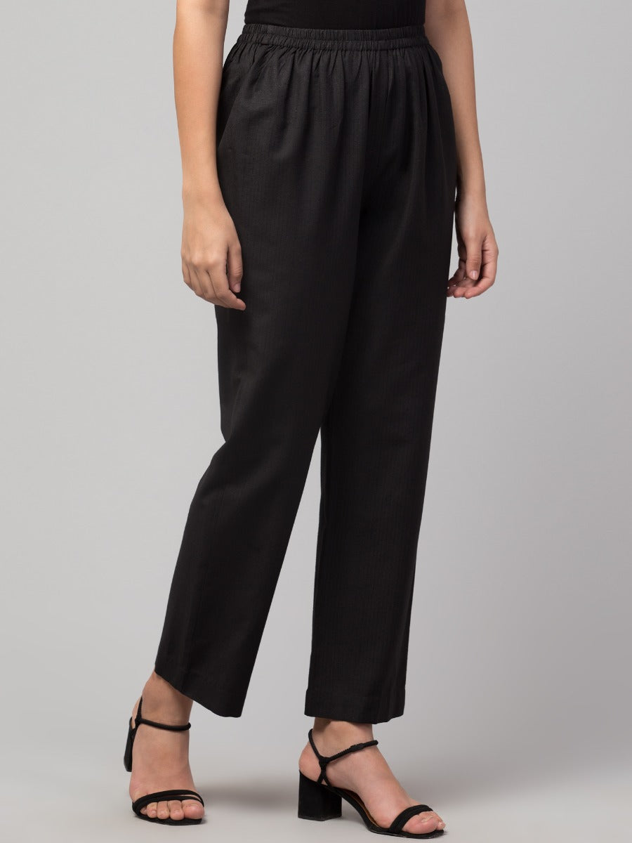 Black solid, high-rise trouser.