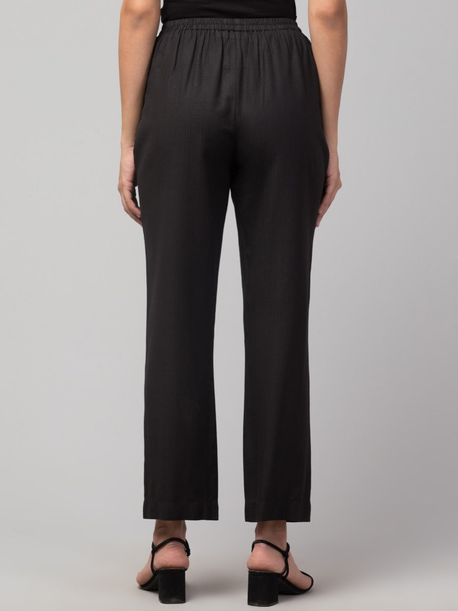 Black solid, high-rise trouser.